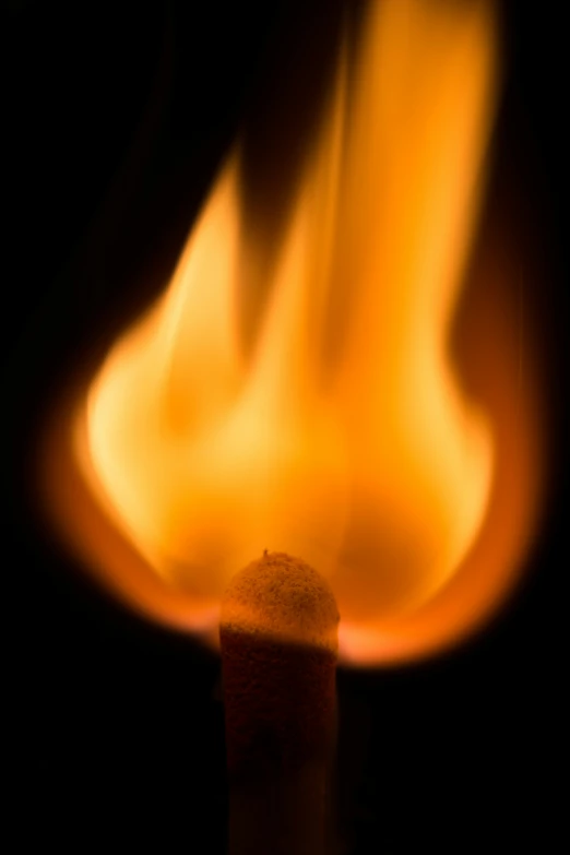 a lighter with flames and oranges in the background