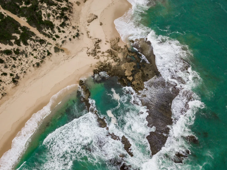 the ocean next to an island near a beach