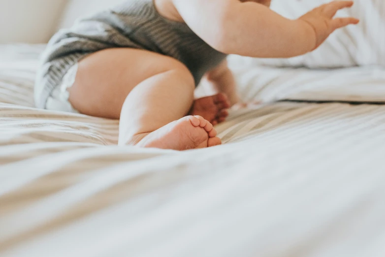 a little baby crawling on the bed