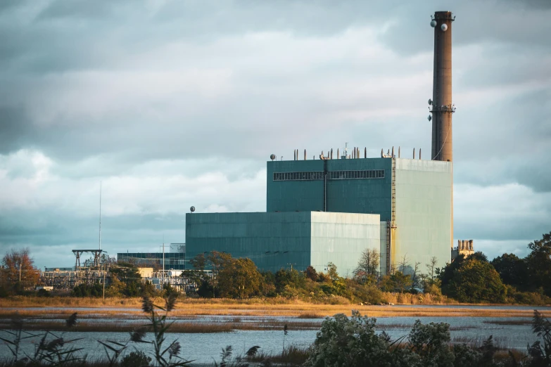 a factory with smoke stacks in the background