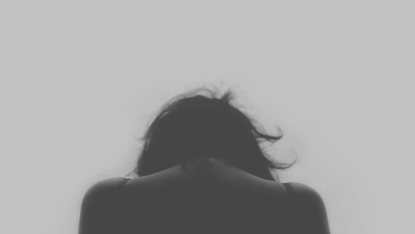 a black and white po of a woman's back