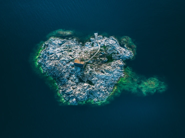 a small island on the water with small rocks on it