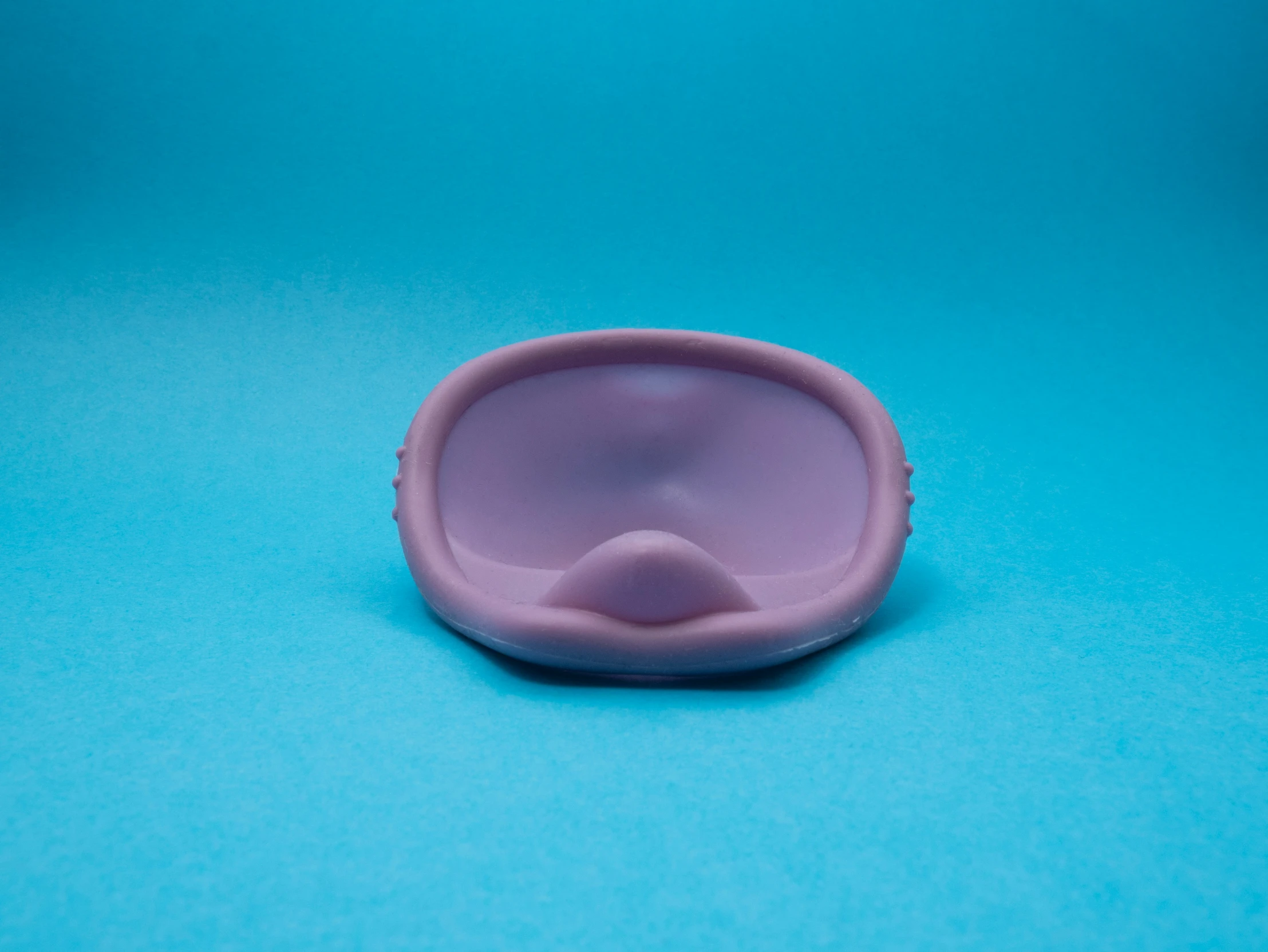 an unlabnished plastic cup sits on a blue background