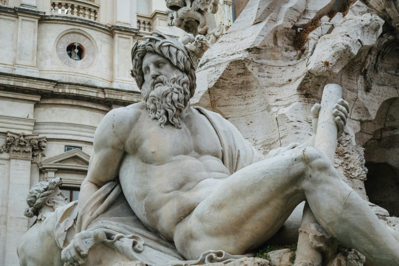 a large statue sitting next to a very tall building