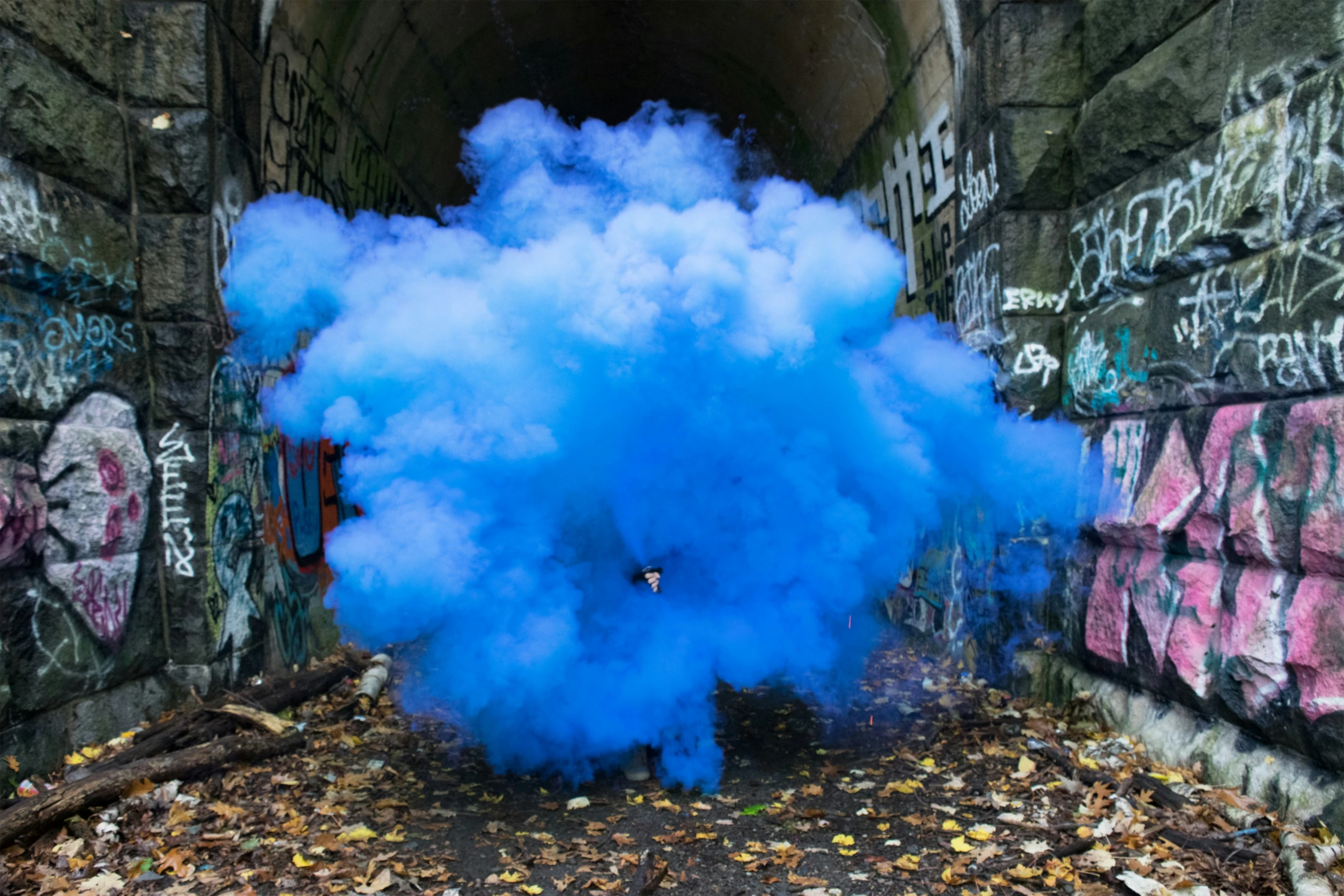 blue powder is blown in the middle of a street