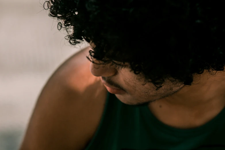 a person with a cellphone with a green shirt