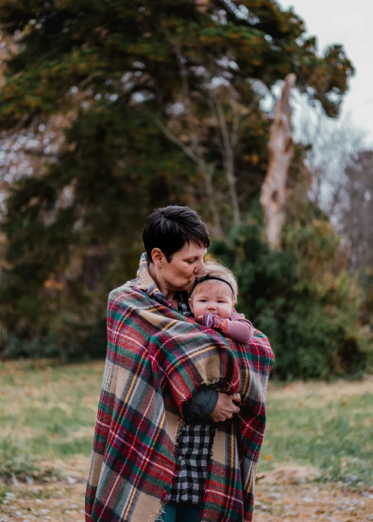 woman and child wrapped in blanket standing together