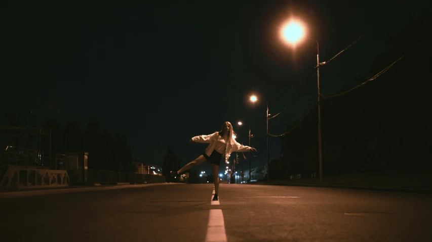 man in black and white shirt doing skateboard trick