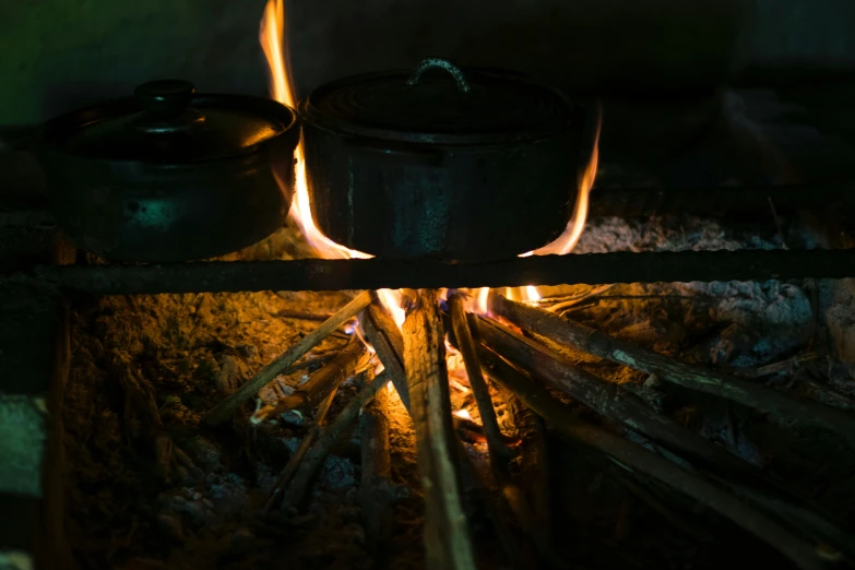some pots are in the grill to cook