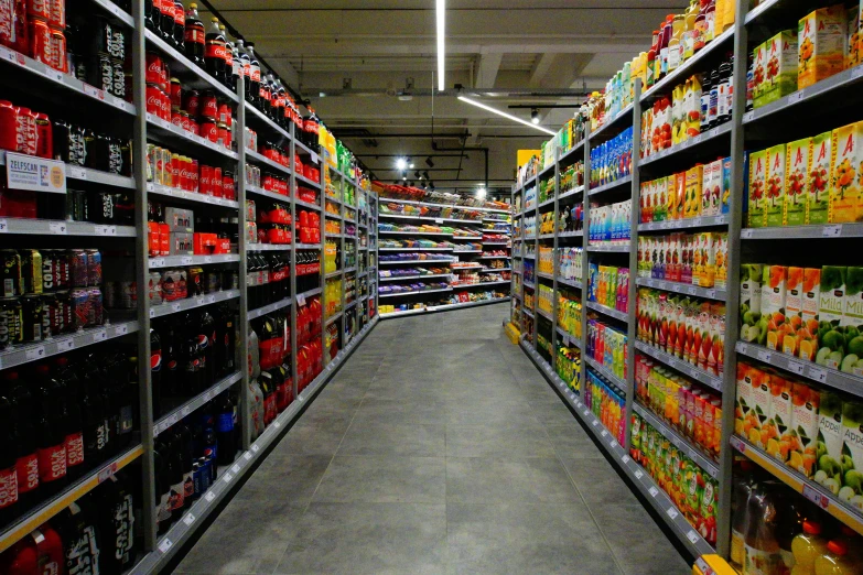 a grocery store aisle filled with cans and bottles of beer