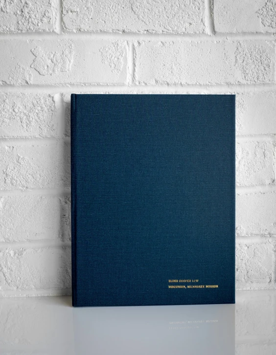 a hardcover blue book sitting on top of a table