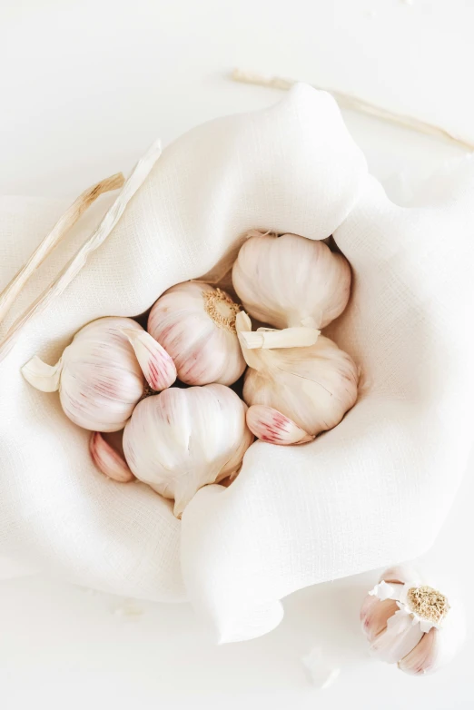 a pile of garlics sitting on top of a white table