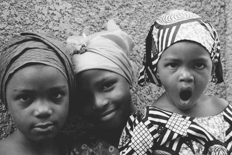 three girls posing for a black and white pograph