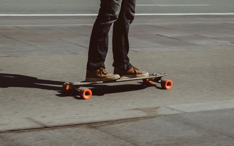 a skateboarder riding on a skateboard down a city street