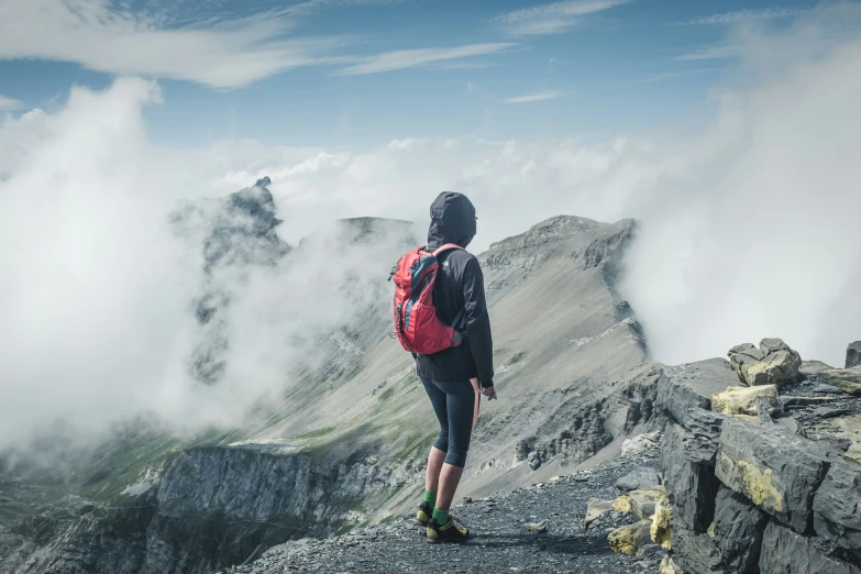 the man is hiking through the rocky terrain