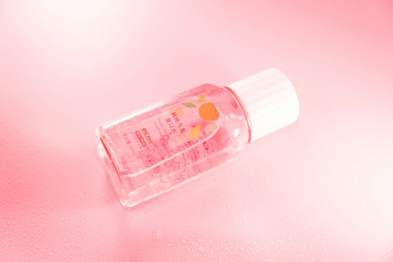 a small plastic bottle that has a pink substance inside