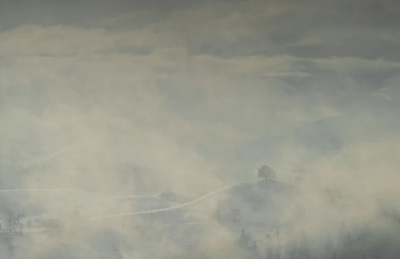 large foggy hill with houses on a cliff