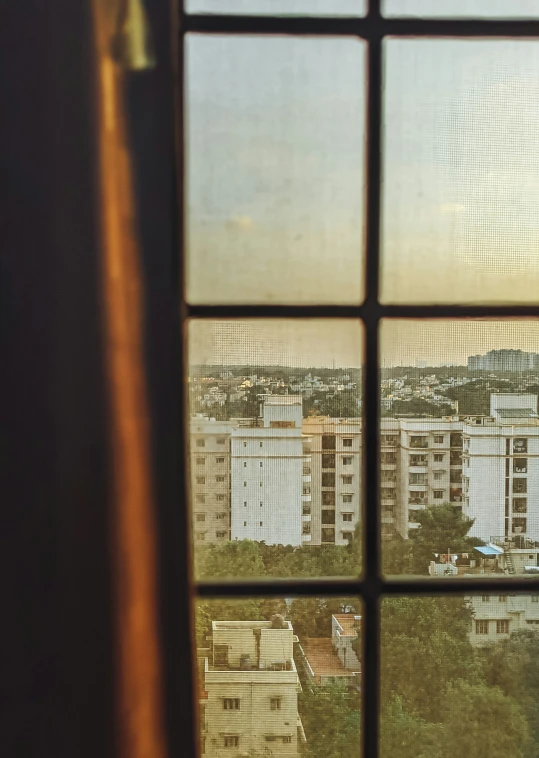 a window with a view of a building and a tree