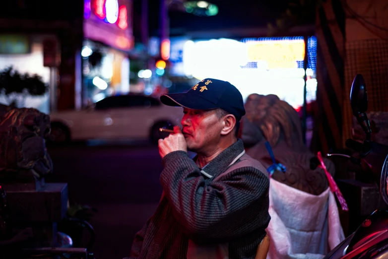 a man standing outside while holding a cell phone