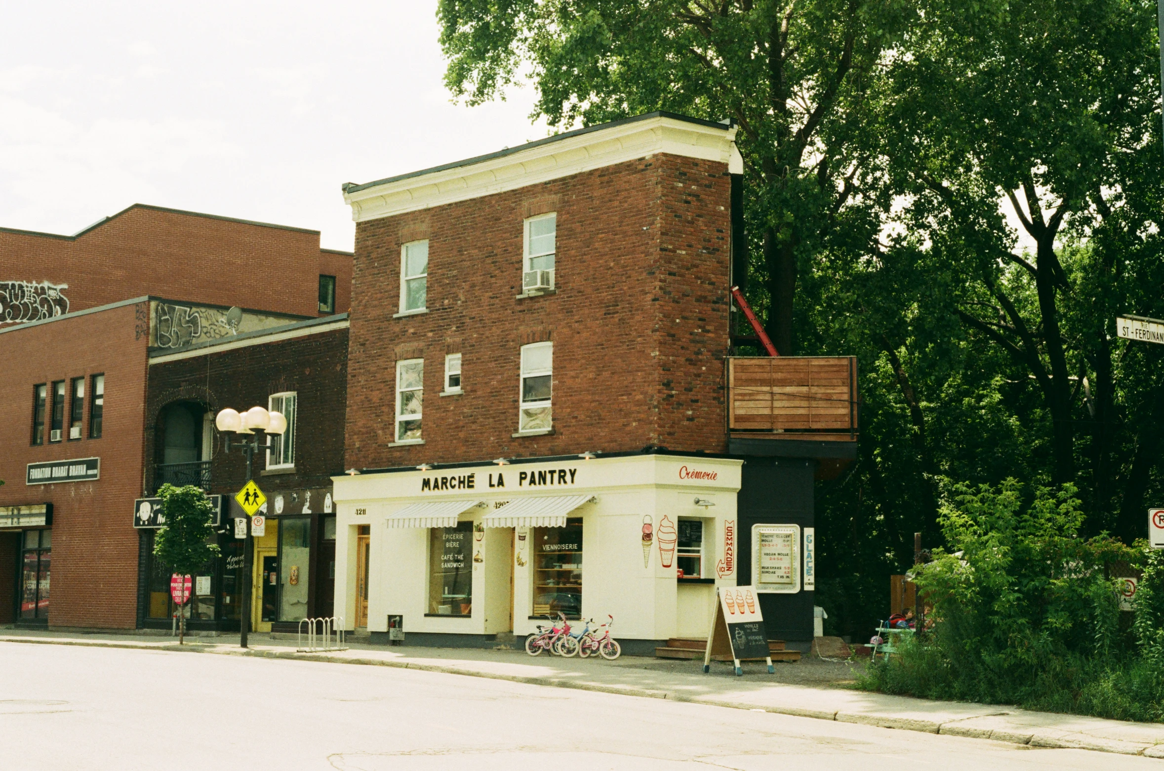 a brick building with lots of windows and a sign in front