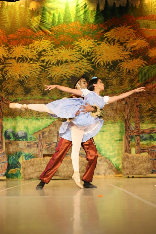 a man and woman doing a dance routine together