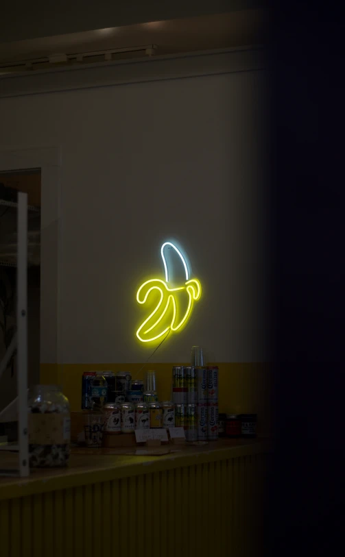 the banana neon sign in the corner of the room