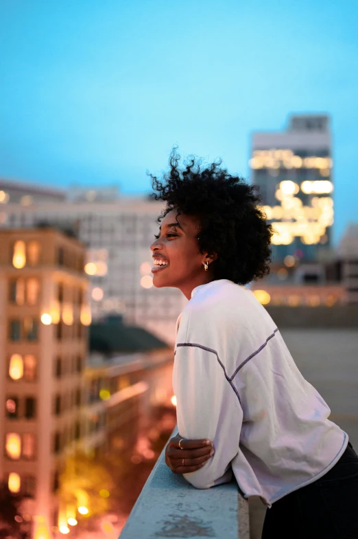 a woman sitting on top of a building