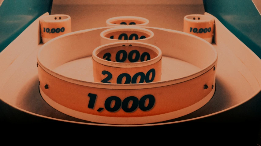 numbered numbers are in an orange bowl on the edge of a table