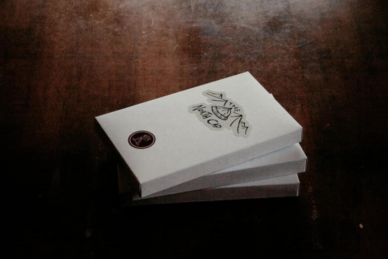a stack of four folded up business cards