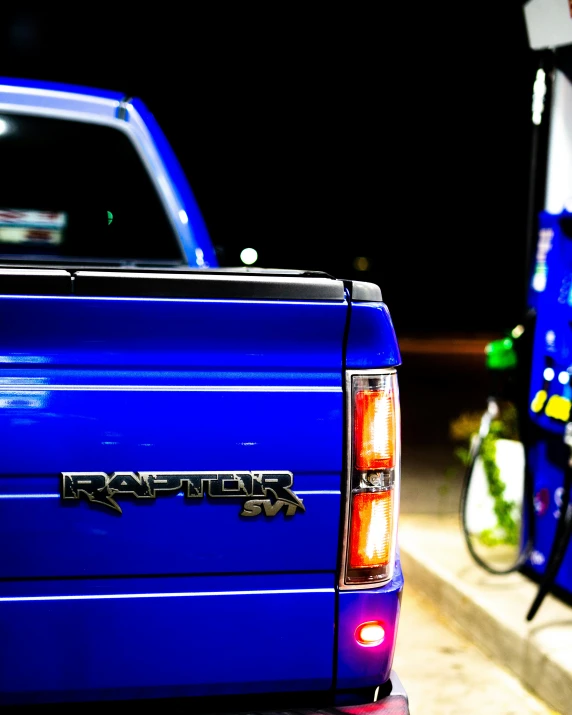 a blue truck parked next to a motorcycle