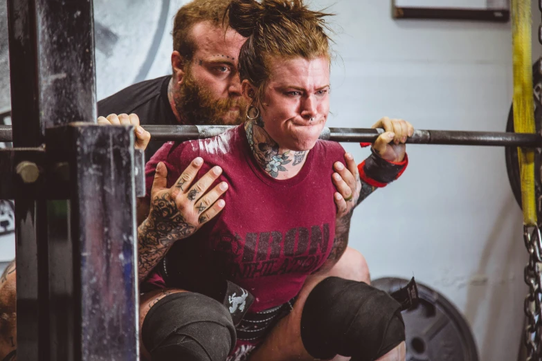 a woman lifts a man on top of her