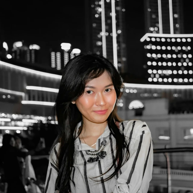 a woman wearing a striped top smiling at the camera