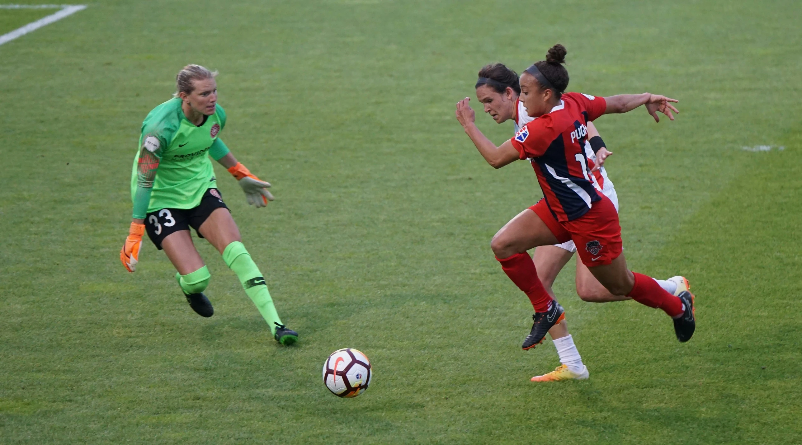 a group of women are on the field playing soccer