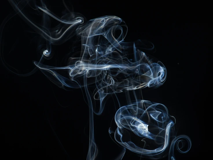 a pograph of smoke on a black background