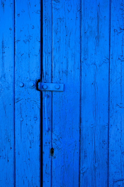 a blue door is seen against the sky