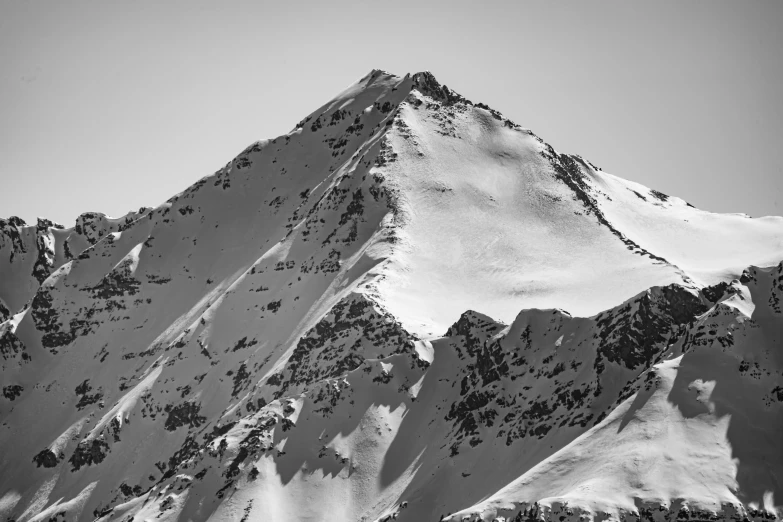 the snow - capped mountain of an alpine region in the winter