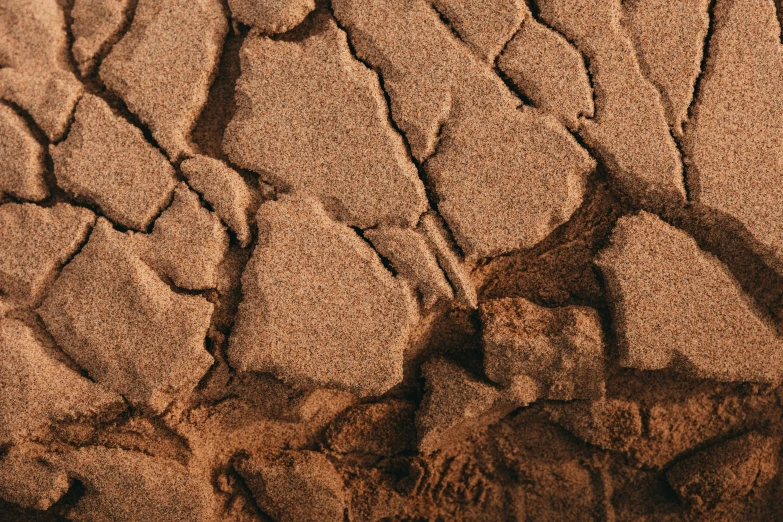 textured rocks with a sandy floor are shown