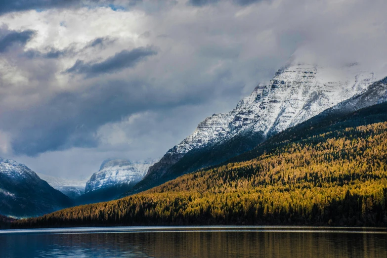 a large mountain with a lake in front of it