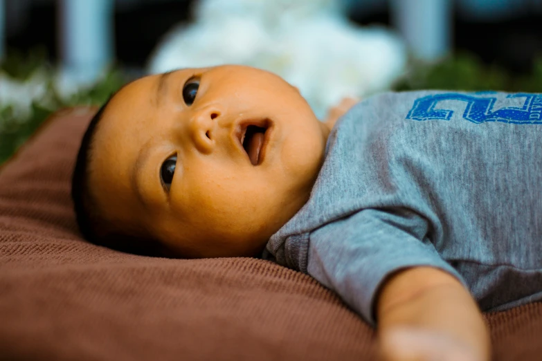 an infant lays on it's back in a bed