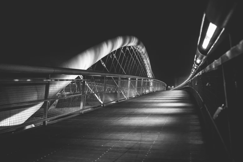 black and white image of an illuminated walkway