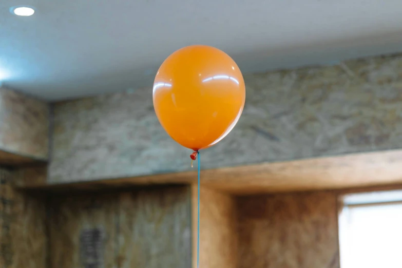 a ballon on a stick suspended from the ceiling in a room