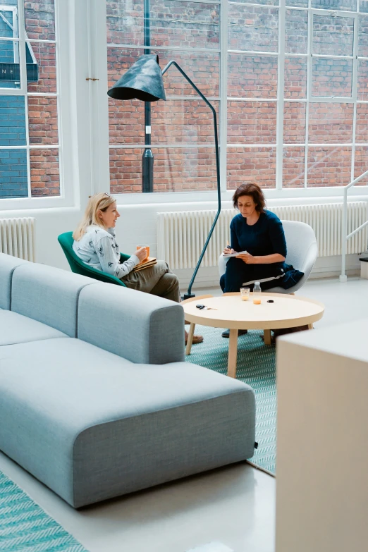 two women sitting around in a living room