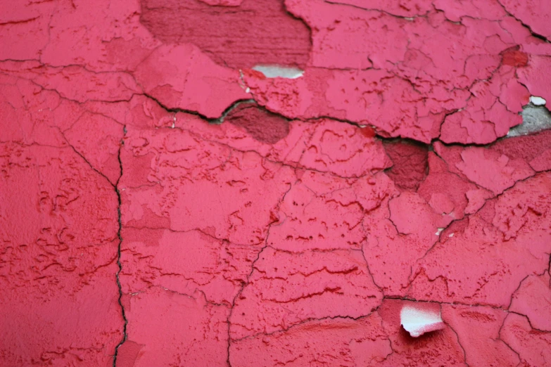 a piece of old and rusty red paint