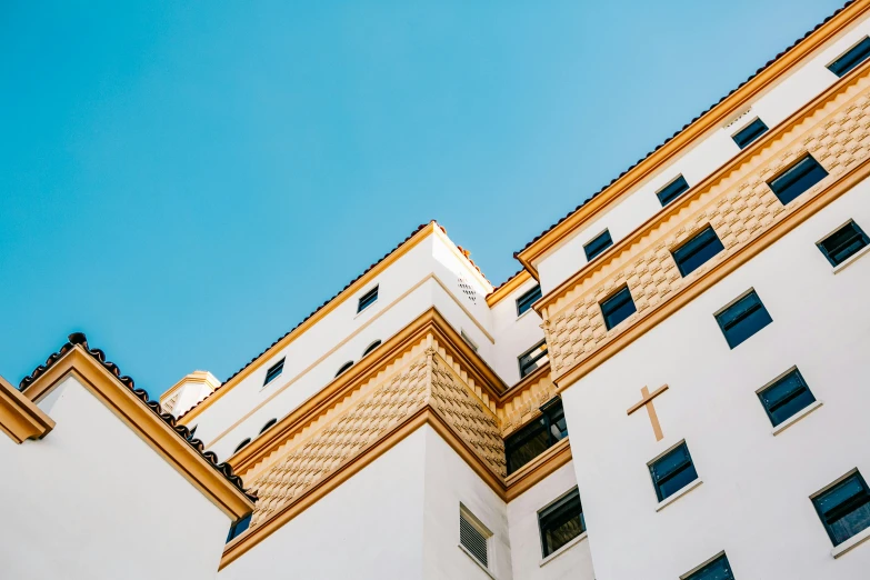 white buildings with golden trim against a blue sky