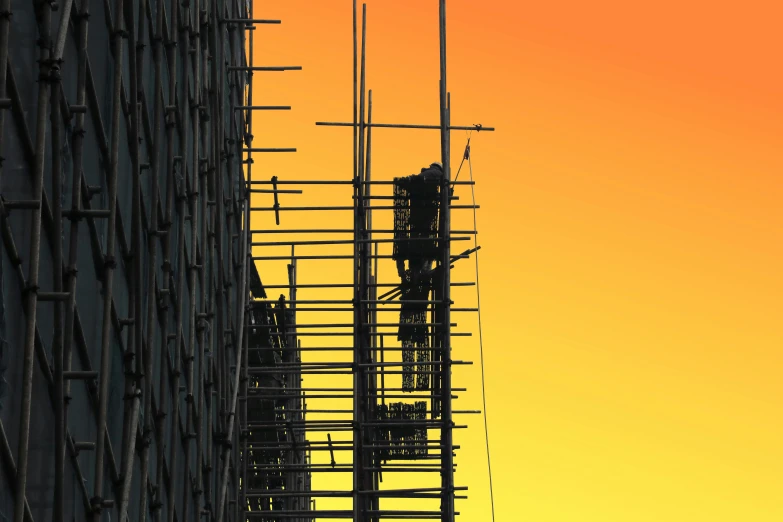 an artistic image of a building with scaffolding in front of the sky