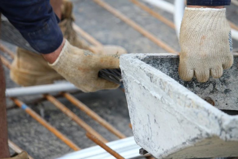 an image of man installing cement on a building