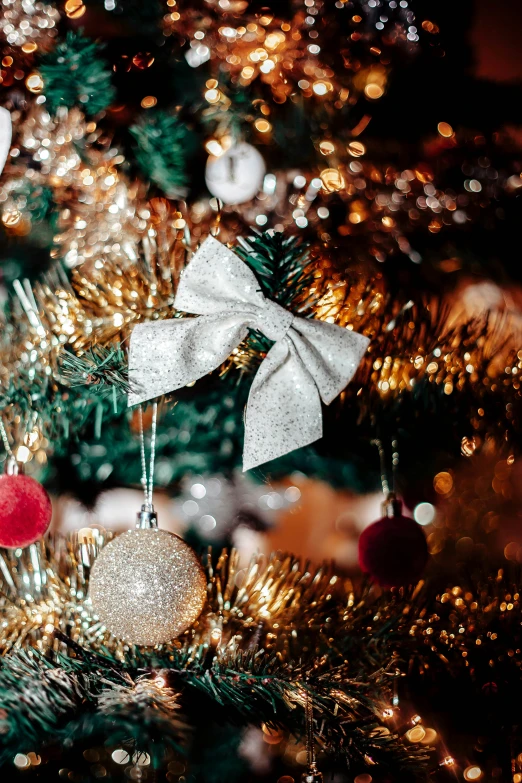 some ornaments are sitting on top of the christmas tree