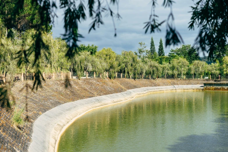 an empty beach near some water and trees