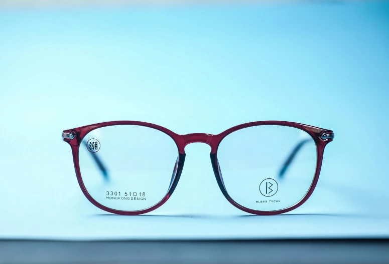 a pair of red glasses with blue light blocking the reflection