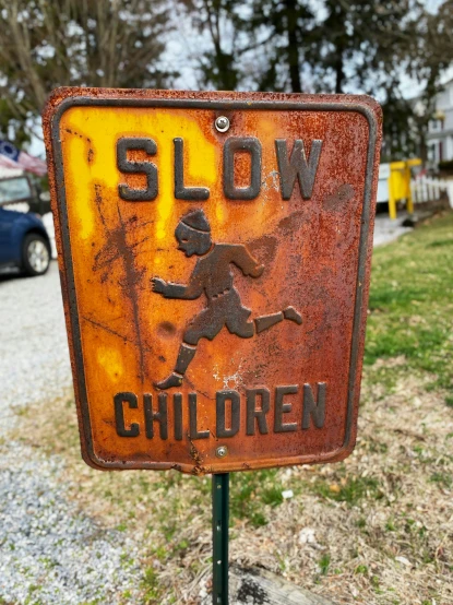 the sign is old and rusted and shows a soccer goalie